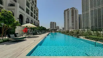 a swimming pool in the middle of a city with buildings at Tranquil & Modern 2BR - Vida Residence Creek Beach in Dubai