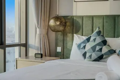 a bedroom with a bed with a large window at Tranquil & Modern 2BR - Vida Residence Creek Beach in Dubai