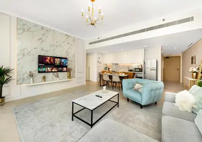 a living room with a couch and a table at La Vie Beachside Elegance in Dubai