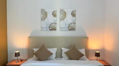 a bedroom with a bed with two pictures above it at Premium 2 Bedroom at Creek Horizon in Dubai