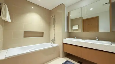 a bathroom with two sinks and a bath tub at Premium 2 Bedroom at Creek Horizon in Dubai