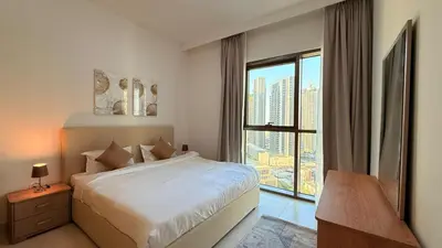 a bedroom with a bed and a large window at Premium 2 Bedroom at Creek Horizon in Dubai
