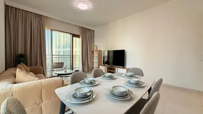 a living room with a table and a couch at Premium 2 Bedroom at Creek Horizon in Dubai
