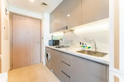 a kitchen with a sink and a washing machine at Studio Near Dubai Creek, Dubai Frame & Downtown, Farhad Azizi, Al Jaddaf by Deluxe Holiday Homes in Dubai