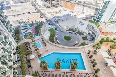 an overhead view of an apartment complex with a pool at Studio Near Dubai Creek, Dubai Frame & Downtown, Farhad Azizi, Al Jaddaf by Deluxe Holiday Homes in Dubai