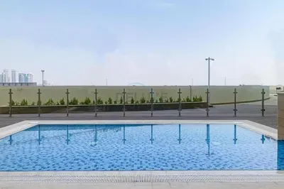 a large swimming pool with blue water at Studio Near Dubai Creek, Dubai Frame & Downtown, Farhad Azizi, Al Jaddaf by Deluxe Holiday Homes in Dubai