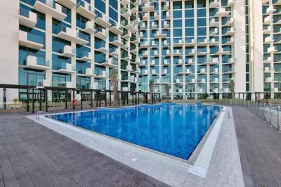 a swimming pool in front of a building at Studio Near Dubai Creek, Dubai Frame & Downtown, Farhad Azizi, Al Jaddaf by Deluxe Holiday Homes in Dubai