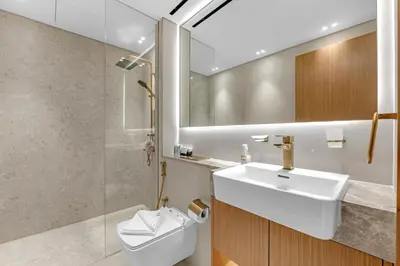 a bathroom with a sink and a toilet and a mirror at 1 Bedroom in Binghatti Lavender in Dubai