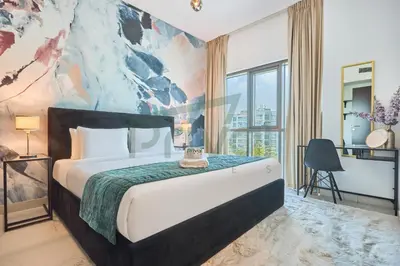 a bedroom with a large bed with a painting on the wall at Prival - Sunlit Serenity 1BR Retreat in Dubai