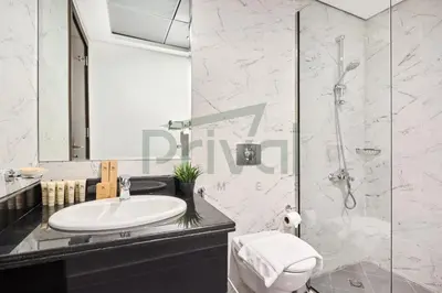 a bathroom with a sink and a shower at Prival - Sunlit Serenity 1BR Retreat in Dubai