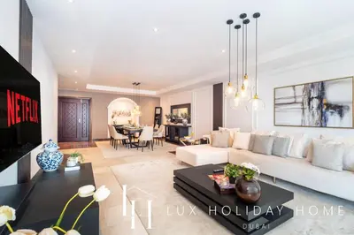 a living room with a white couch and a table at LUX The Al Seef Marina 4 bed Suite in Dubai