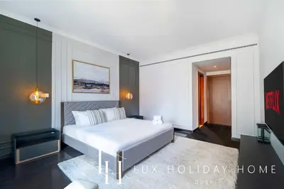 a bedroom with a white bed in a room at LUX The Al Seef Marina 4 bed Suite in Dubai