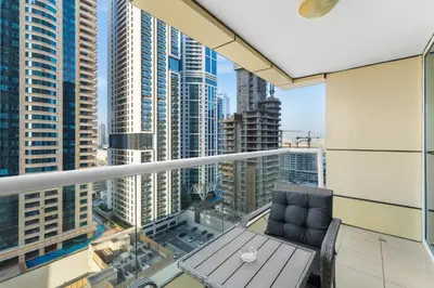 a balcony with a bench and a view of a city at Stylish 1BR in Marina, Balcony Near JBR in Dubai