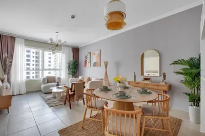 a living room with a table and chairs at Dubai Marina Promenade 1BR Apartment with Pool near JBR in Dubai