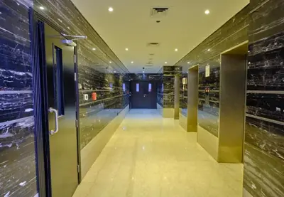 a hallway of a building with a glass door at Single Bed In Twin Room With Balcony For Female Guests Only in Dubai