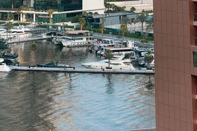 a view of a marina with boats in the water at Cosy Studio, 7-min walk Burj Khalifa and Dubai Mall in Dubai