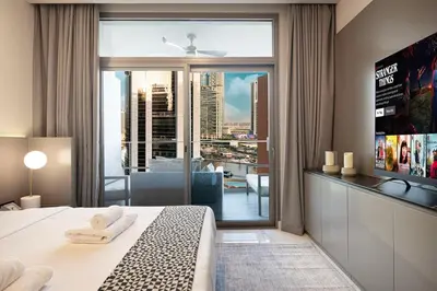 a bedroom with a bed and a large window at Cosy Studio, 7-min walk Burj Khalifa and Dubai Mall in Dubai