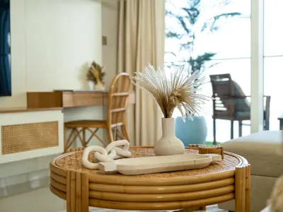 a coffee table with a vase and towels on top of it at Luxury Spacious 2 Bedroom Private Beach and Views in Dubai