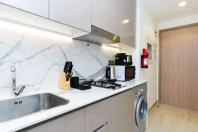 a kitchen with a sink and a counter top at CitiHome - Studio Azizi Riviera in Dubai