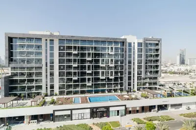 an office building with a pool in front of it at CitiHome - Studio Azizi Riviera in Dubai