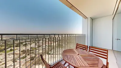 a balcony with a table and chairs and a view at Downtown Views 3 - Chic One Bed with City Views in Dubai