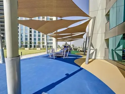 a building with a patio with awning and chairs at Downtown Views 3 - Chic One Bed with City Views in Dubai