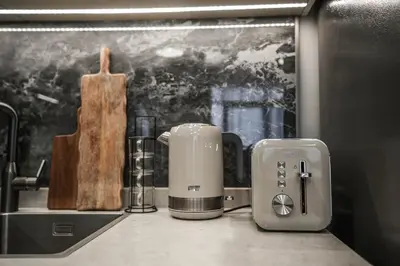 a toaster sitting on a counter next to a sink at QUARTZ Luxe 1-Bed at Nobles Tower, Near Downtown in Dubai