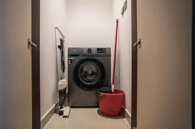 a washer and dryer in a hallway of a room at QUARTZ Luxe 1-Bed at Nobles Tower, Near Downtown in Dubai