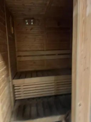 a small wooden sauna with a wooden floor at Dubai Marina No 9 in Dubai