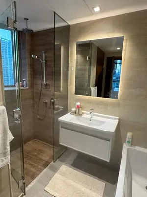 a bathroom with a sink and a shower with a mirror at Dubai Marina No 9 in Dubai