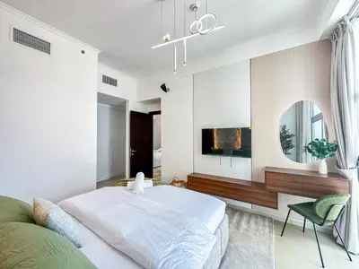 a bedroom with a large bed and a mirror at Upgrade Unit for 6 pax with Sea View Ideal Location Near Beach Big Balcony in Dubai