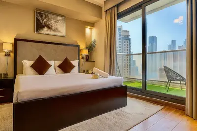 a bedroom with a large bed and a large window at Premium 3BR Downtown Retreat with Pool & Iconic Burj Views in Dubai