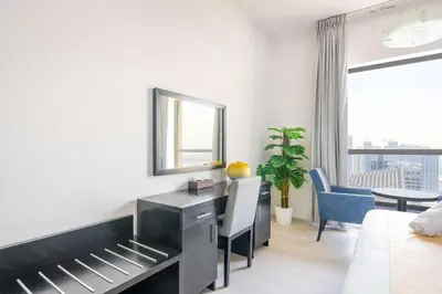 a bedroom with a bed and a desk with a mirror at Luxury JBR 2BR Shams Full Marina View Free 5 Star Beach Resorts Access in Dubai