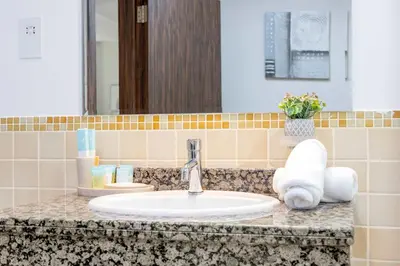 a bathroom counter with a sink and a mirror at Luxury JBR 2BR Shams Full Marina View Free 5 Star Beach Resorts Access in Dubai