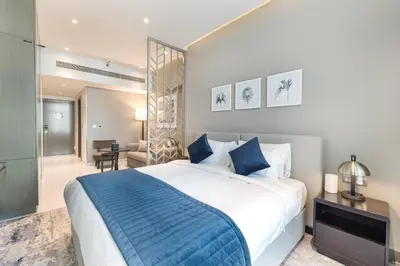 a bedroom with a large bed with a blue blanket at ALiving Luxury Studio with Balcony Views Prive 2007B in Dubai