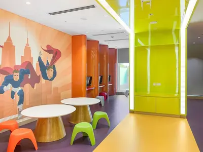 a cafeteria with two tables and colorful chairs at ALiving Luxury Studio with Balcony Views Prive 2007B in Dubai