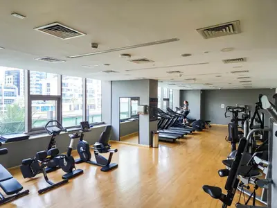 a gym with treadmills and elliptical machines at Stunning 1BR with Breathtaking Views Dubai Marina in Dubai