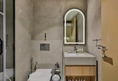 a bathroom with a sink and a mirror at Studio Apartment in Burj View Residence, Arjan - Allsopp & Allsopp in Dubai