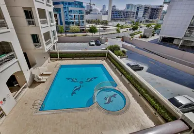 an overhead view of a swimming pool on top of a building at Studio Apartment in Burj View Residence, Arjan - Allsopp & Allsopp in Dubai