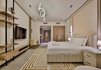 a bedroom with a large bed and a tv at Studio Apartment in Burj View Residence, Arjan - Allsopp & Allsopp in Dubai