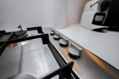 a stove top with many knobs on it at Luxury 1BR Suite - Comfort Meets Class in Dubai