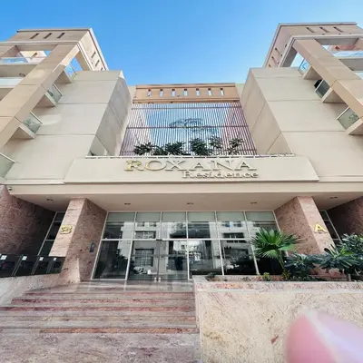 a view of the front of a building at Modern 1BR w Pool and Parking At Roxana Residence in Dubai
