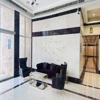 a living room with a purple couch and chairs at Modern 1BR w Pool and Parking At Roxana Residence in Dubai