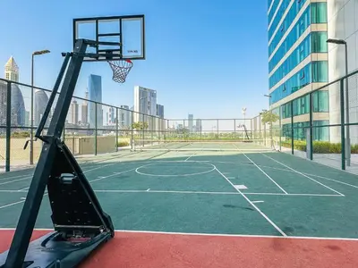 a basketball hoop on a tennis court in a city at Luxurious 1BR High Floor Skyline View Downtown in Dubai