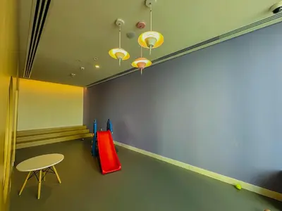 a room with a table and a red slide at Luxurious 1BR High Floor Skyline View Downtown in Dubai