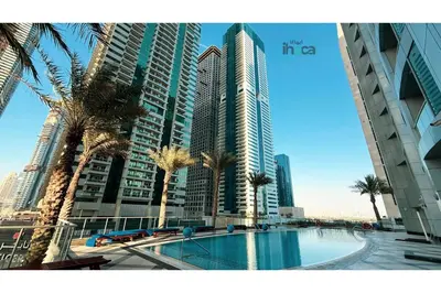 a view of a city with palm trees and buildings at 71st Floor Luxury 1Br Spacious Skyline Balcony in Dubai