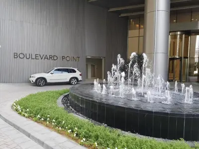 a white car parked in front of a building with a fountain at Elegant apartment Dubai downtown in Dubai