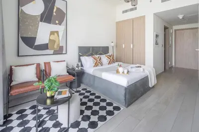 a bedroom with a large bed and a table at Frank Porter - Azizi Riviera 36 in Dubai