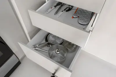 an open kitchen drawer with a pot in it at Luxury Stay at Marina Vista, Dubai Harbour in Dubai