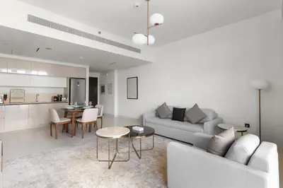 a living room with a couch and a table at Luxury Stay at Marina Vista, Dubai Harbour in Dubai